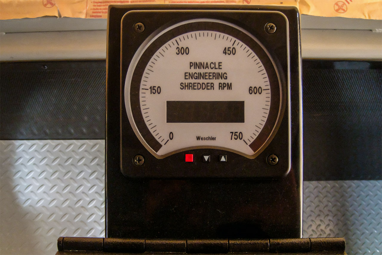 pinnacle-shredding-spot Close-up of a gauge labeled "Pinnacle Engineering Shredder RPM" displaying 0 to 750, with a digital screen and two indicator lights—essential for precision in industrial metal recycling operations.